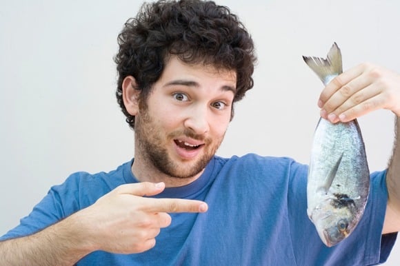 Man Holding a Whole Fish