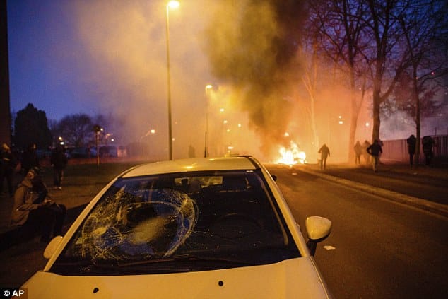 Cars have also been smashed by demonstrators, pictured, despite the victim calling for 'calm' during the investigation