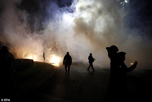 Officers have responded by firing tear gas at the protesters, pictured