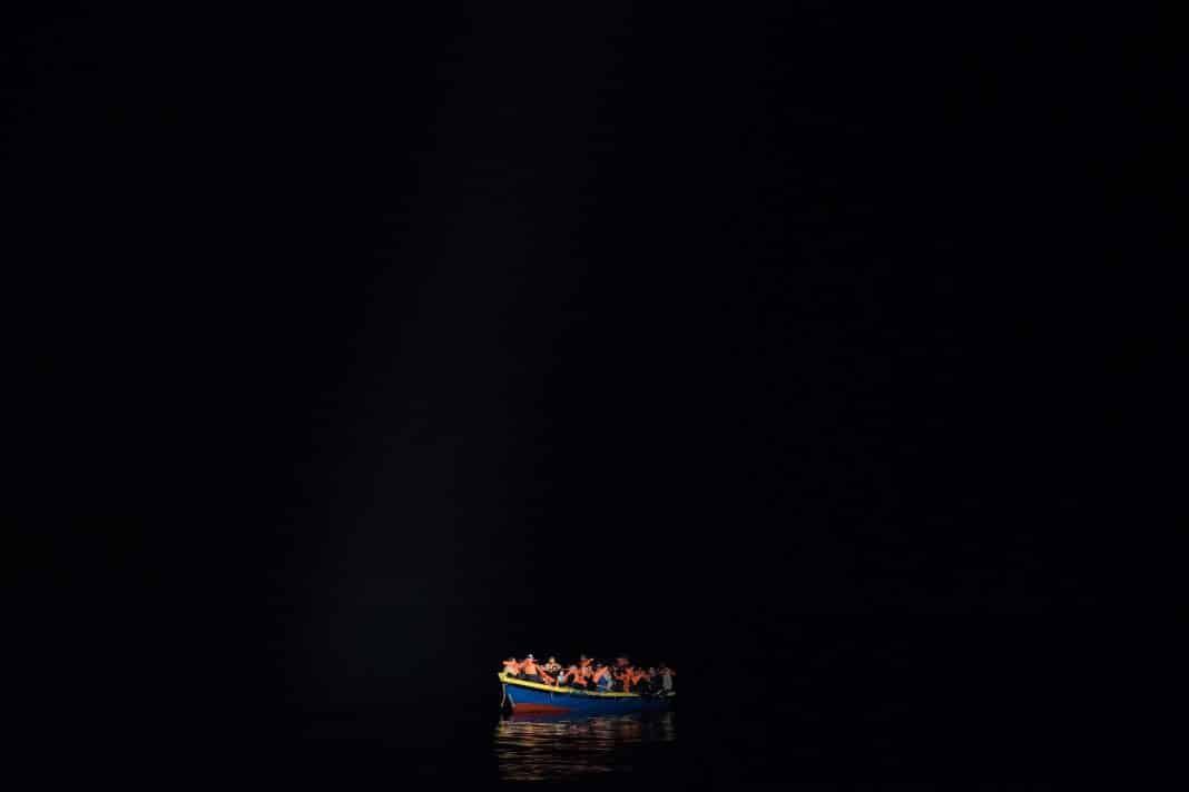 POZZOLLO, ITALY - NOVEMBER 22: A wooden boat carrying refugees and migrants waits to be escorted to the Topaz Responder as members of MOAS, Migrant Offshore Aid Station make rescues at sea on November 22nd, 2016 in Pozzollo, Italy. The MOAS team worked through the night and into the next morning rescuing 'approximately' 600 people from vessels though that figure could change. MOAS are currently patrolling international waters off the coast of Libya, and running rescue missions for the many migrants and refugees who continue to attempt to make the dangerous crossing across the Mediterranean Sea to Italy. MOAS are a Malta based registered foundation dedicated to providing professional search-and-rescue assistance to refugees and migrants in distress at sea and work alongside with the Red Cross on board the Topaz Responder. The number of deaths this year of people crossing the Mediterranean has risen to almost 4,300. MOAS alone have rescued around 19,000. (Photo by Dan Kitwood/Getty Images)